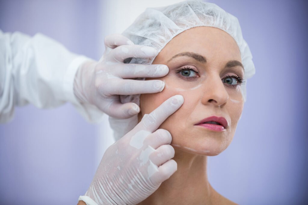 close up of doctor examining female patients face for cosmetic treatment